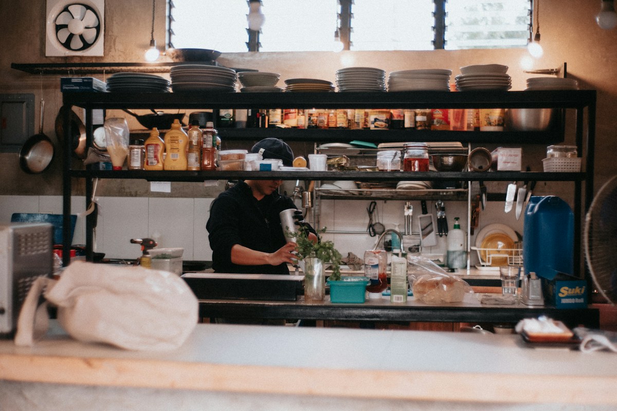 A man in a kitchen preparing food on a counter in the Philippines