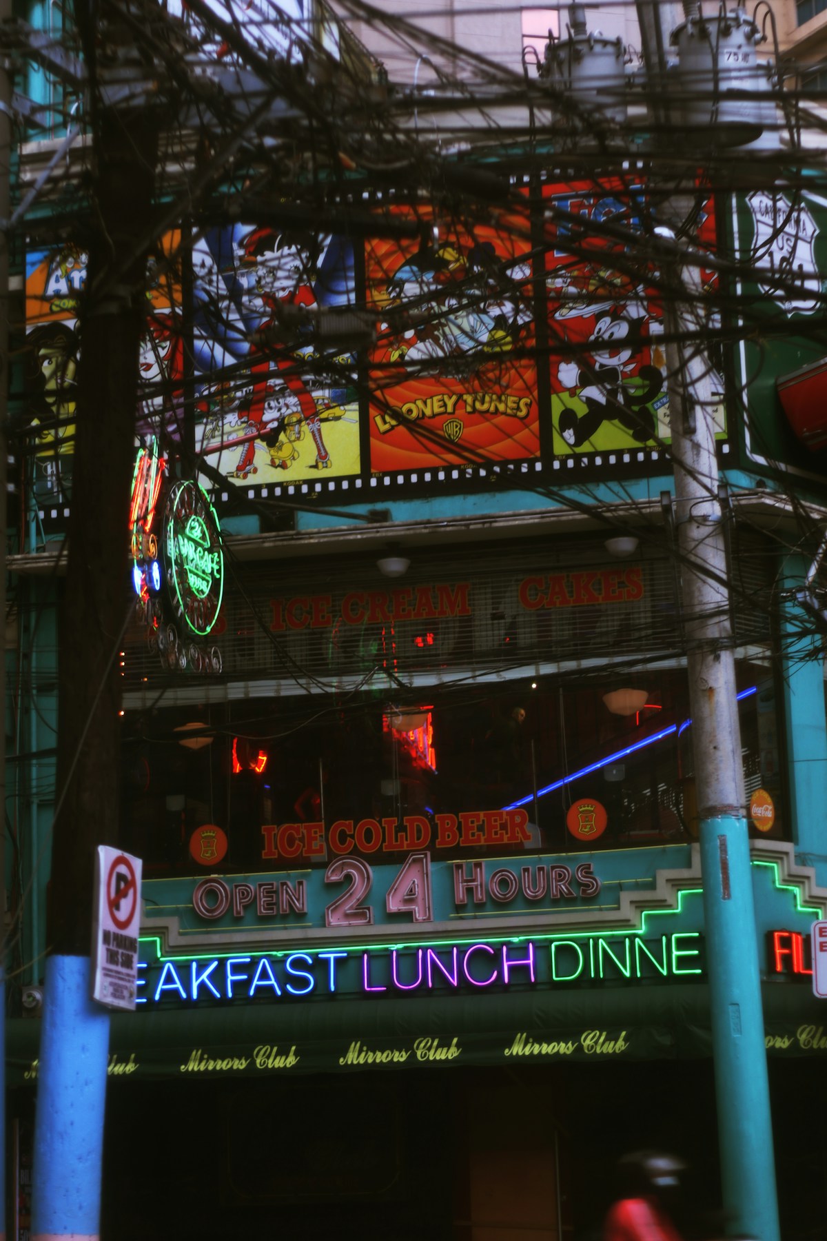 A restaurant with neon signs on the front of it in the Philippines