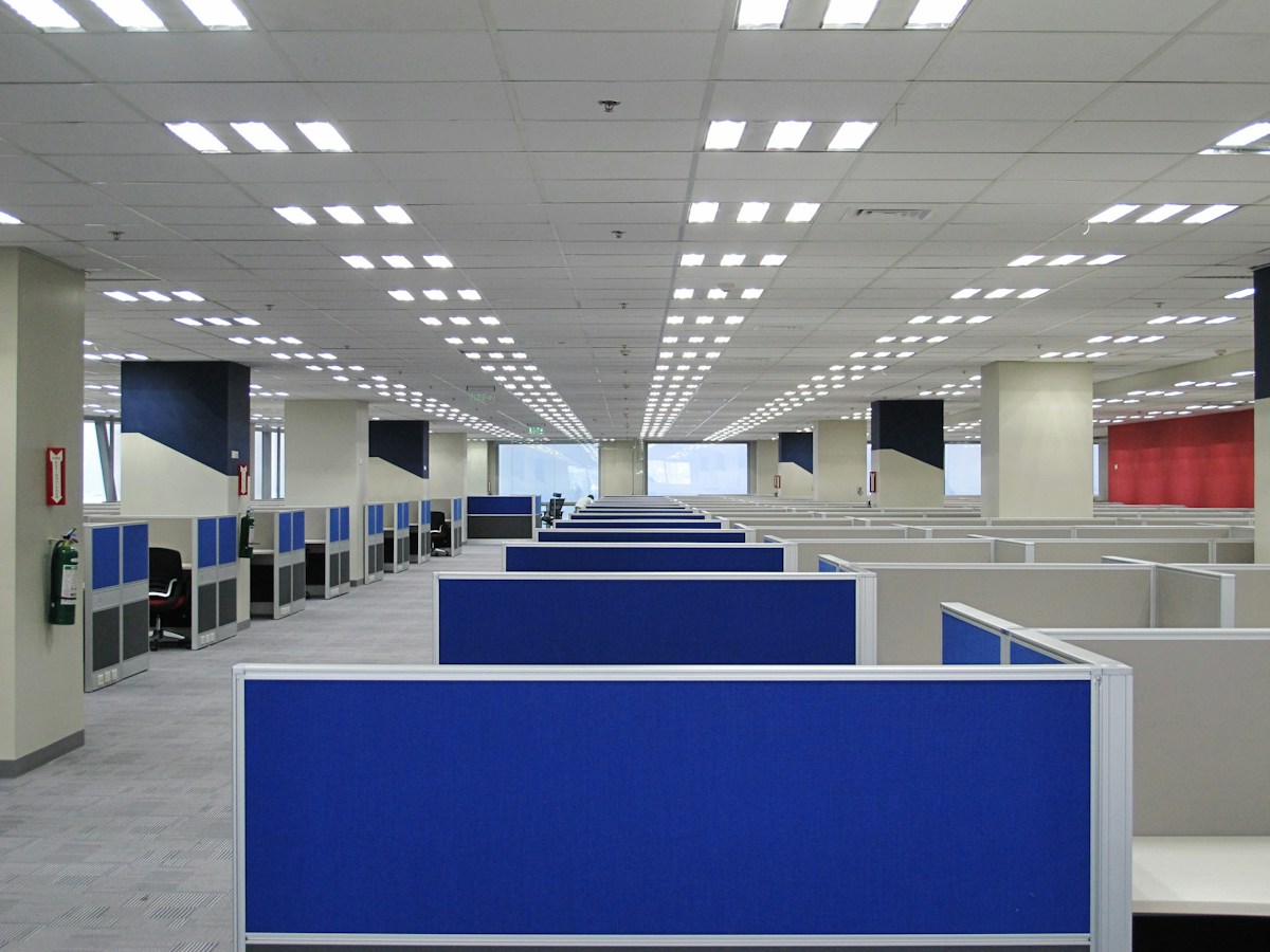 An empty office with blue and white cubicles in the Philippines